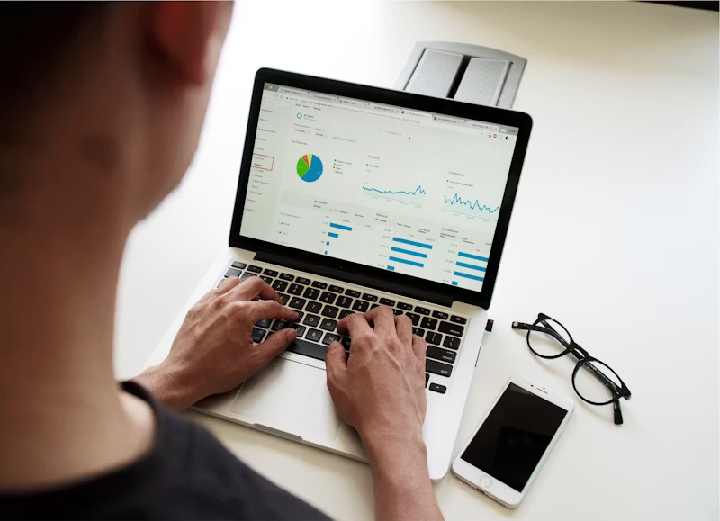 Person using a MacBook Pro to review retirement accounts